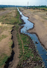 Cracked earth, drying up small river in the steppe zone in southern Ukraine