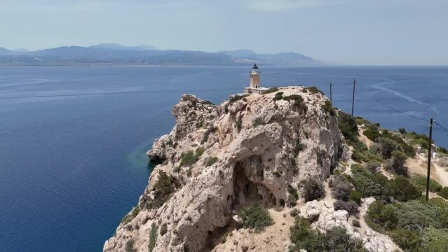 Aerial drone photo of beautiful and picturesque cape Melagavi forming a small peninsula with unique lighthouse stand out next to archaeological site of Heraion, Loutraki, Greece