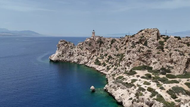 Aerial drone photo of beautiful and picturesque cape Melagavi forming a small peninsula with unique lighthouse stand out next to archaeological site of Heraion, Loutraki, Greece