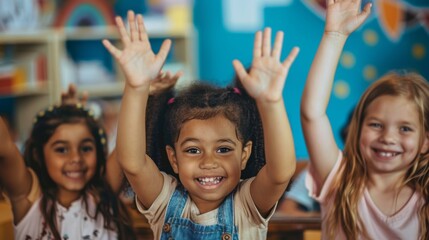 Fototapeta premium School children in classroom at lesson raising their hands.