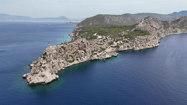 Aerial drone photo of beautiful and picturesque cape Melagavi forming a small peninsula with unique lighthouse stand out next to archaeological site of Heraion, Loutraki, Greece