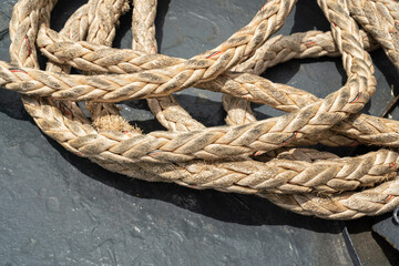 Nautical vessel heavy rope or mooring rope. this rope will anchor for stability when the ship is docking at harbour. Transportation equipment object photo, selective focus.