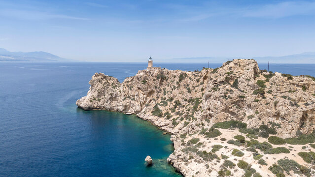 Aerial drone photo of beautiful and picturesque cape Melagavi forming a small peninsula with unique lighthouse stand out next to archaeological site of Heraion, Loutraki, Greece