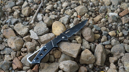 Hunting Knife on a brown gravel background