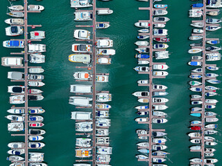 Marina with yachts in Puerto de Mogan, a small fishing port on Gran Canaria, Spain, Cinematic aerial overview of yacht marina.