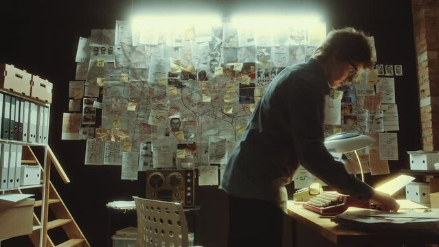 Time lapse of female detective working in the office at night: she using analog typewriter, reviewing documents, talking on phone and attaching clues to evidence board