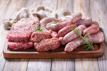 Mix of fresh meat products for grill on cutting board