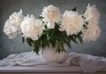 bouquet of peonies flowers in a white jar