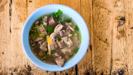 Breakfast soup with blue bowl on wooden table