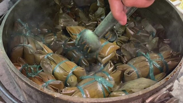 Buras or Burasa, Bugis Makassar food made from coconut milk rice wrapped in banana leaf and boiled. Traditional kitchen in rural life.