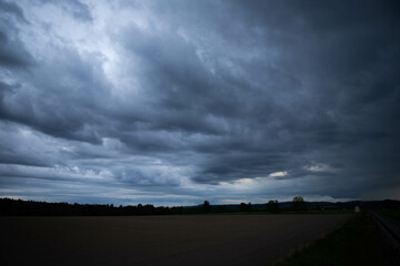 Obraz premium storm clouds over the field, blue sky