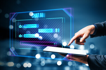 Close up of businessman hand pointing at tablet with creative ai chat hologram on blurry bokeh...