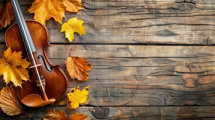 Obraz premium Autumn leaves and antique violin on rustic wooden table top view space to copy