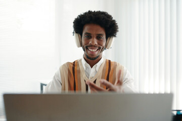 Fototapeta premium Portrait of cheerful entrepreneurs talking to coworkers in online meeting