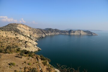 Fototapeta premium Mangla dam's huge blue water Lake, seen from the entrance of the famous and high Ramkot Fort.