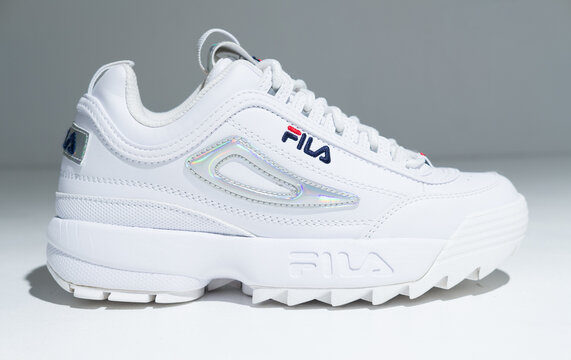 kent, uk, 01.01.2024 fila disruptor 2 White Rainbow festival summer Trainers. Vintage hipster fashionable festival footwear women hi chunky trainers. on trend high street fashion.