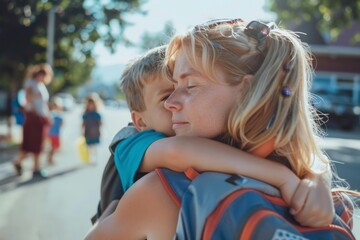 A mother and son embracing emotionally as the school bus waits