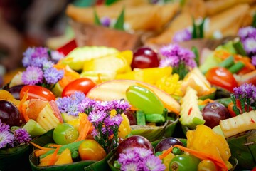 A colorful fruit salad with purple flowers on top
