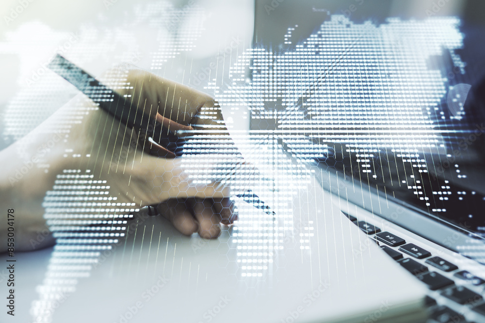 Wall mural double exposure of abstract digital world map and hand writing in notebook on background with laptop