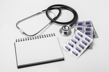 stethoscope equipment and psychotherapy pills melatonin capsule purple healthy on notebook