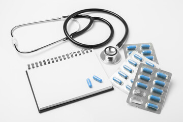 stethoscope equipment and psychotherapy pills modern capsule  blue healthy on notebook