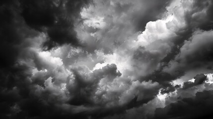 Obraz premium Dramatic black and white photo of stormy clouds gathering in the sky, evoking a sense of impending weather and atmospheric tension.