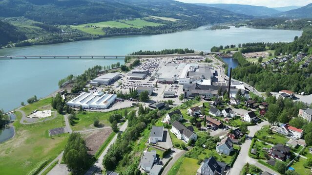 Flying over Strandtorget shopping center. New McDonald's is under construction. Green water in the L&aring;gen delta in the background with an outlet in Mj&oslash;sa
