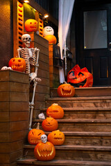 Halloween outdoor decorations. Bright orange pumpkins and skeletons. Halloween celebration in Canada.  