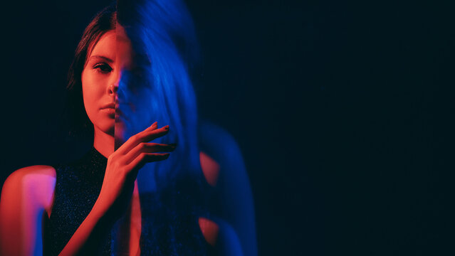 Mental disorder. Defocused woman. Fake calm female silhouette suffering dissociative identity red neon color empty space double exposure out of focus.