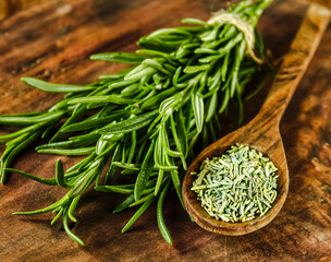 Rosemary in a wooden spoon. Dry and fresh fragrant rosemary, seasonings on a wooden board. Spices and herbs that are used for cooking meat and fish. Culinary concept.