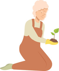 Senior woman gardener kneeling and carefully holding a small plant with soil, concept of gardening, planting, and taking care of plants