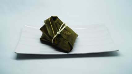 Traditional wrapped rice dumpling or zongzi on a plate