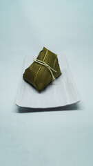 Traditional wrapped rice dumpling or zongzi on a plate