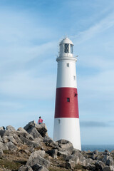 Child walking around lighthouse