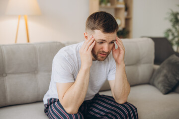 Depressed hopeless man in home wear lying on sofa during mental breakdown, psychotherapy, banner