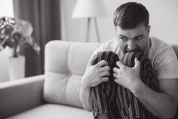 Depressed hopeless man in home wear lying on sofa during mental breakdown, psychotherapy, banner