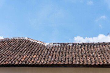 Roof of Red Clay Tiles Under Cloudy Skies