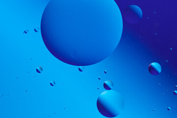 Abstract art featuring vibrant blue hues with bubble like forms.