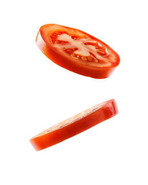 Two fresh slices of tomato falling against a white background, Cut-out