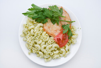 Fried chicken meat with a side dish of pasta. Delicious meat breakfast.