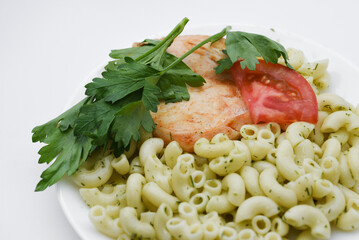 Fried chicken meat with a side dish of pasta. Delicious meat breakfast.