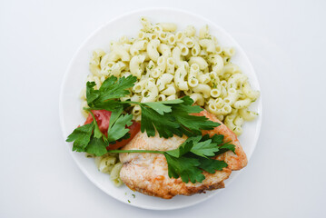 Fried chicken meat with a side dish of pasta. Delicious meat breakfast.