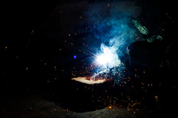Welding Closeup. Bright Sparks and Smoke Looks Very Beautiful. 
