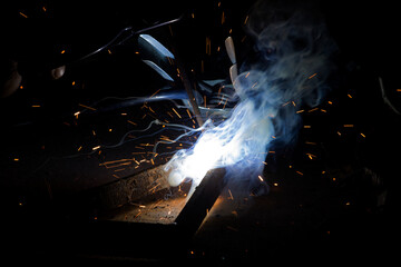 Welding Closeup. Bright Sparks and Smoke Looks Very Beautiful. 
