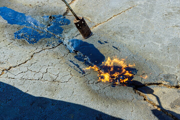 Pavement joints are restored by heating cracks in asphalt prior to filling them with hot bitumen emulsion