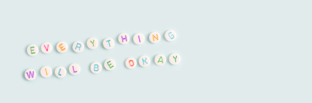 Everything will be okay. Banner with quote made of beads with letters on a blue background. Place for text.