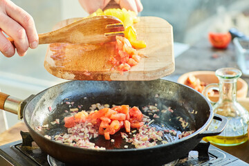 Step-by-step cooking process. Fry the chopped tomatoes together with onions in a preheated frying pan