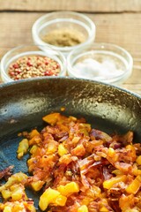 Step-by-step cooking process. Fry the sliced sausage in a frying pan with tomatoes and onions