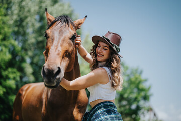 Fototapeta premium Young woman having fun at the ranch, smiling and bonding with a horse on a sunny day.