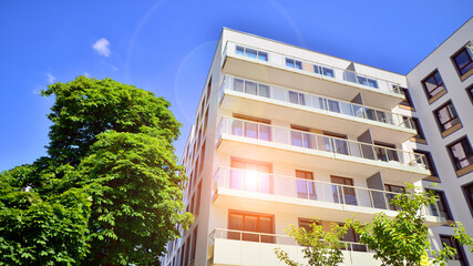 European residential architecture harmonizing with nature. Eco-friendly living in city with greens. Eco apartment building saving energy and fresh air concept. 